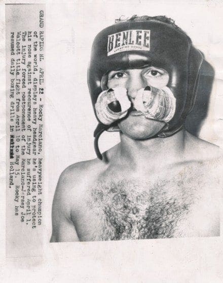 Vintage 7" x 9" press photo of Rocky Marciano displaying his heav...